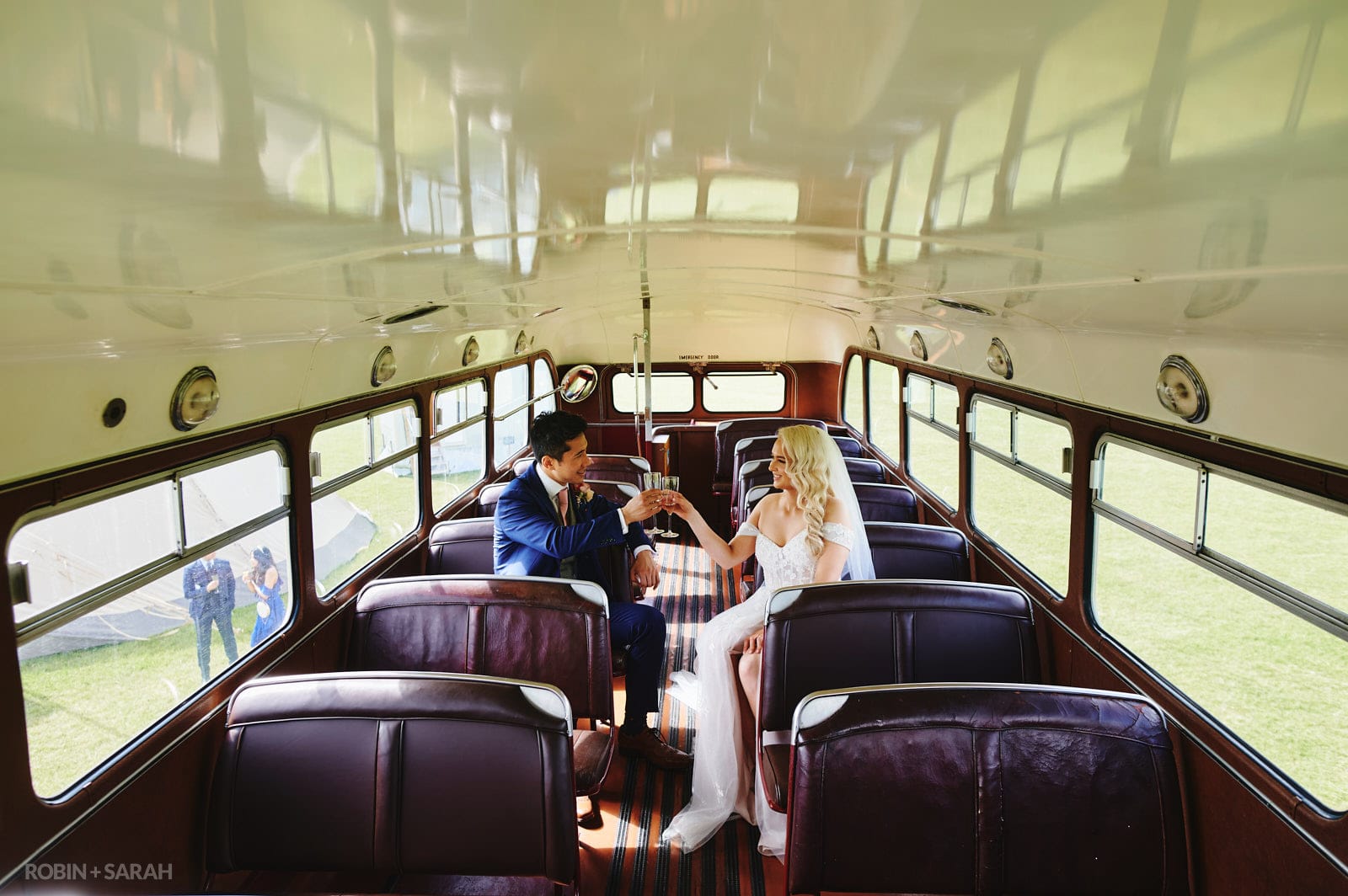 Bride and groom on red bus