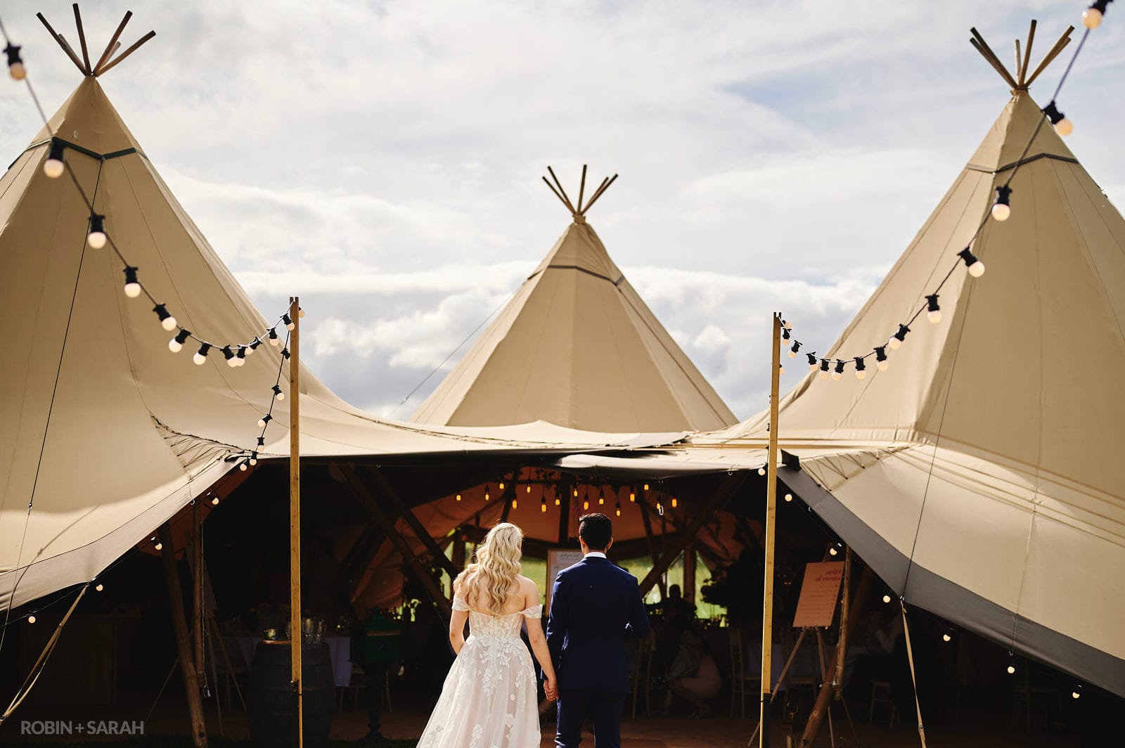 Bride and groom enter tipi for meal at Alcott Farm