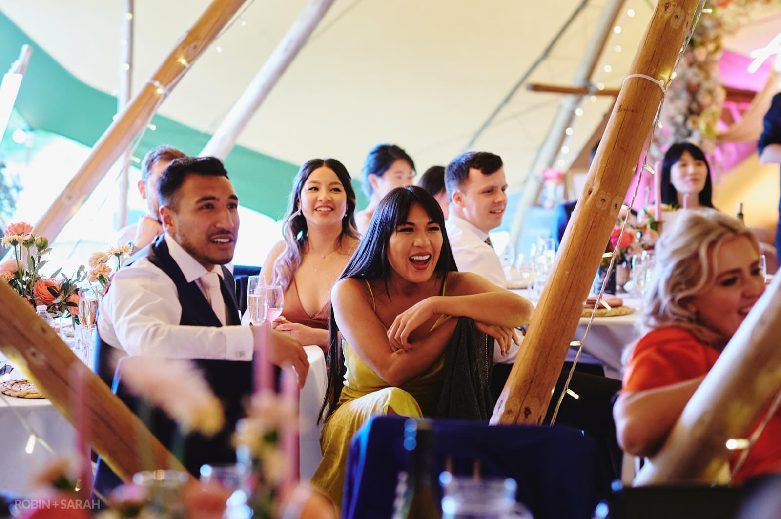 Guests laughing at wedding speeches
