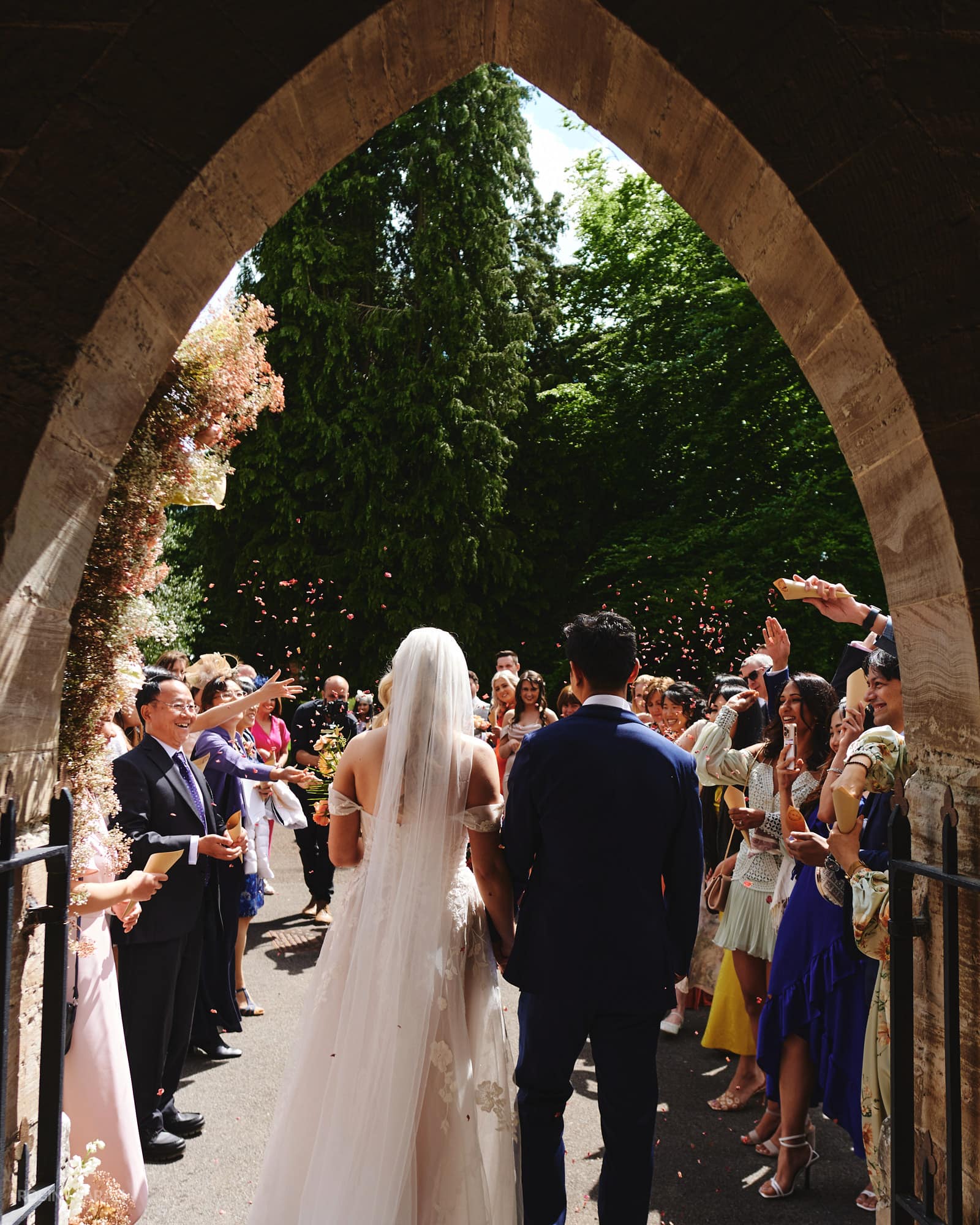 Bride and groom walk out to confetti throw from Feckenham Church