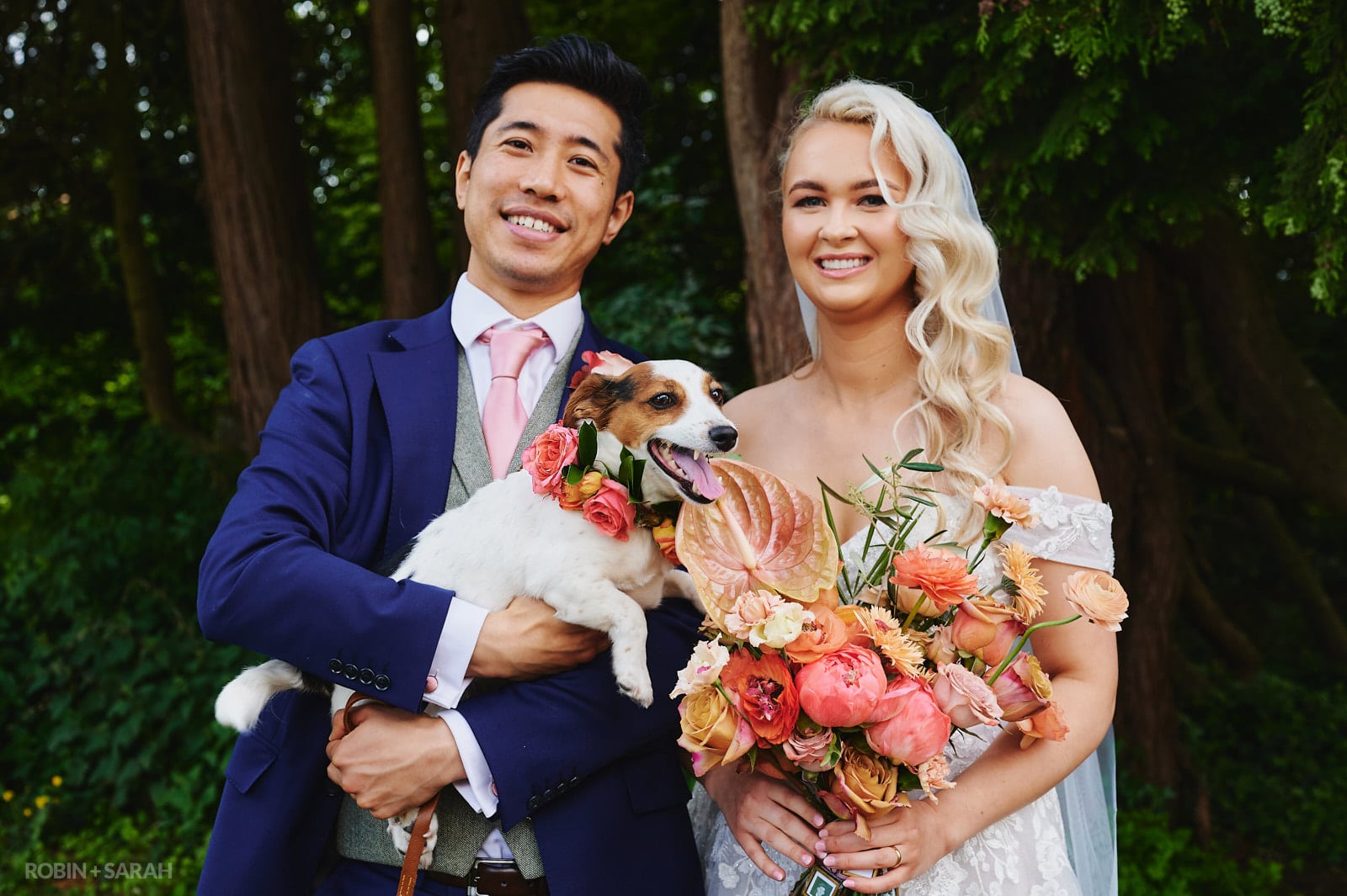 Bride and groom pose for photo with their dog