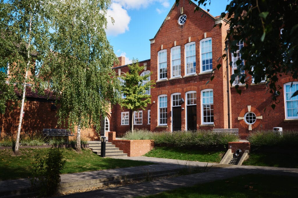 View of Bromsgrove Registration Office from courtyard with trees and blue sky