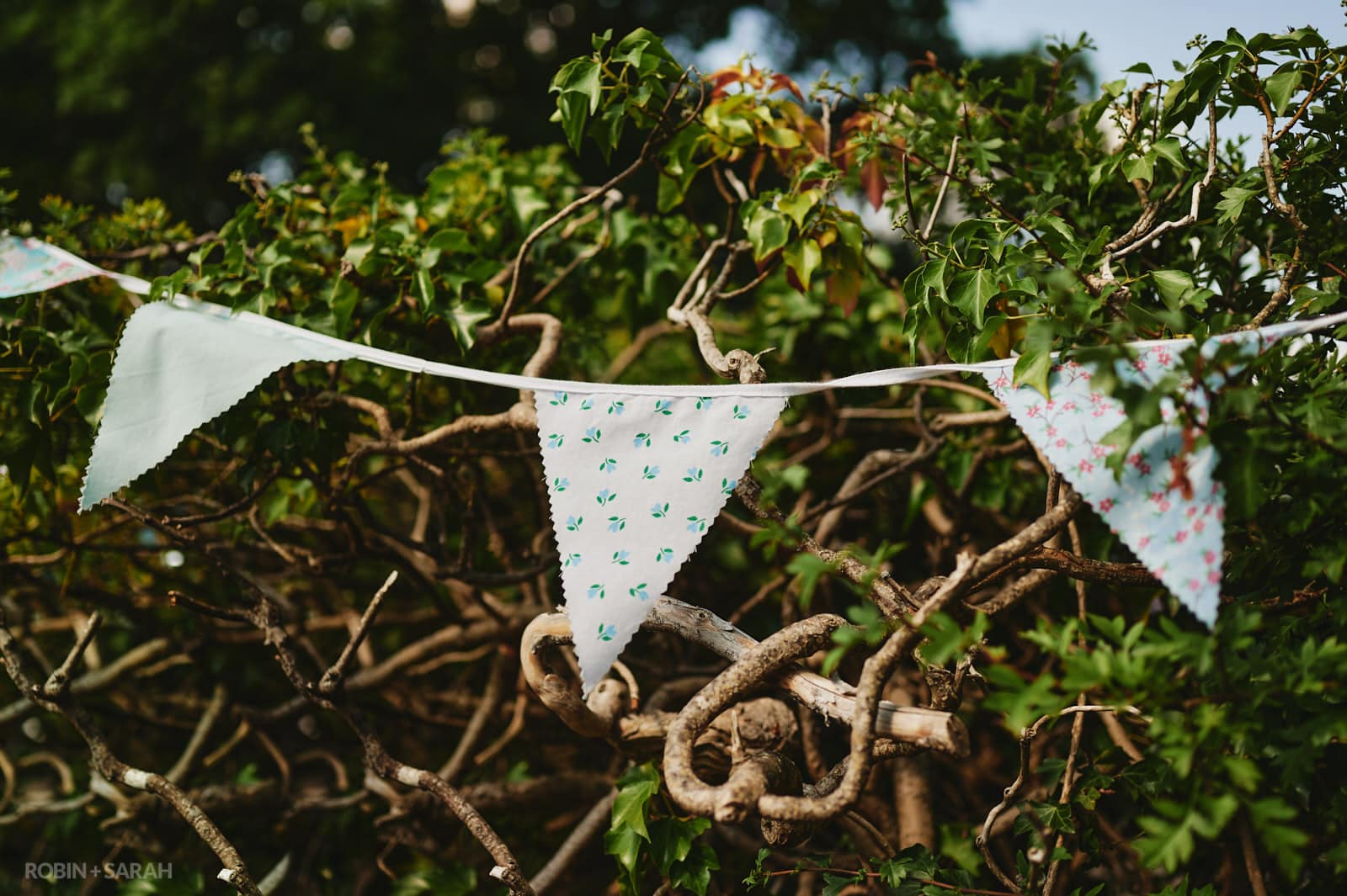 Bunting laid out on a hedgerow for wedding