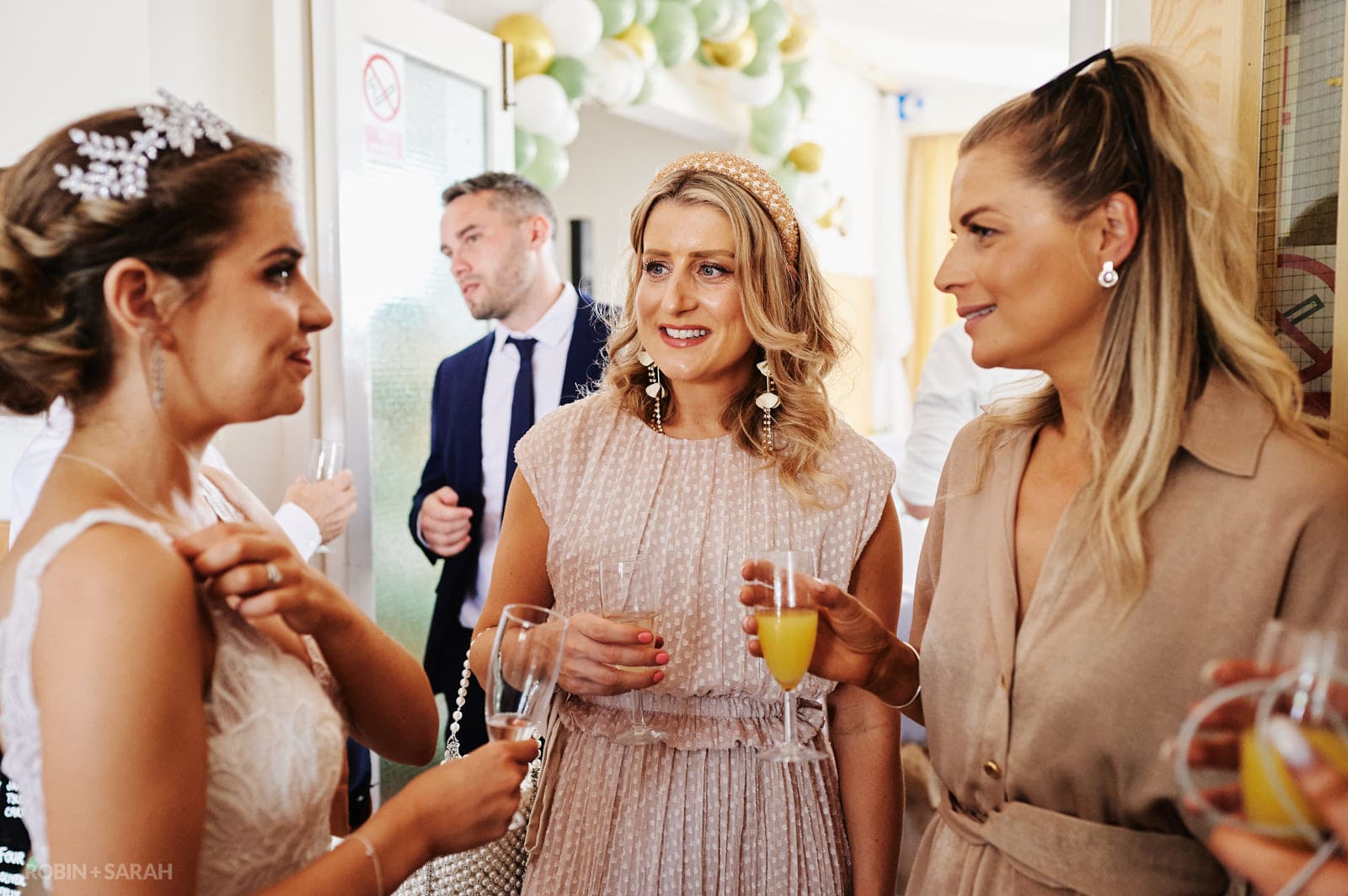 Bride chats to guests at Bentley Village Hall wedding reception