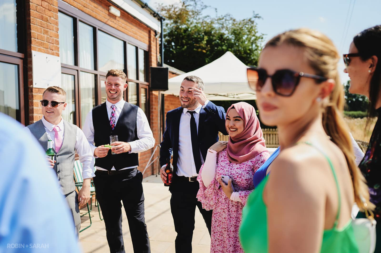 Wedding guests chat and relax at Bentley Village Hall reception