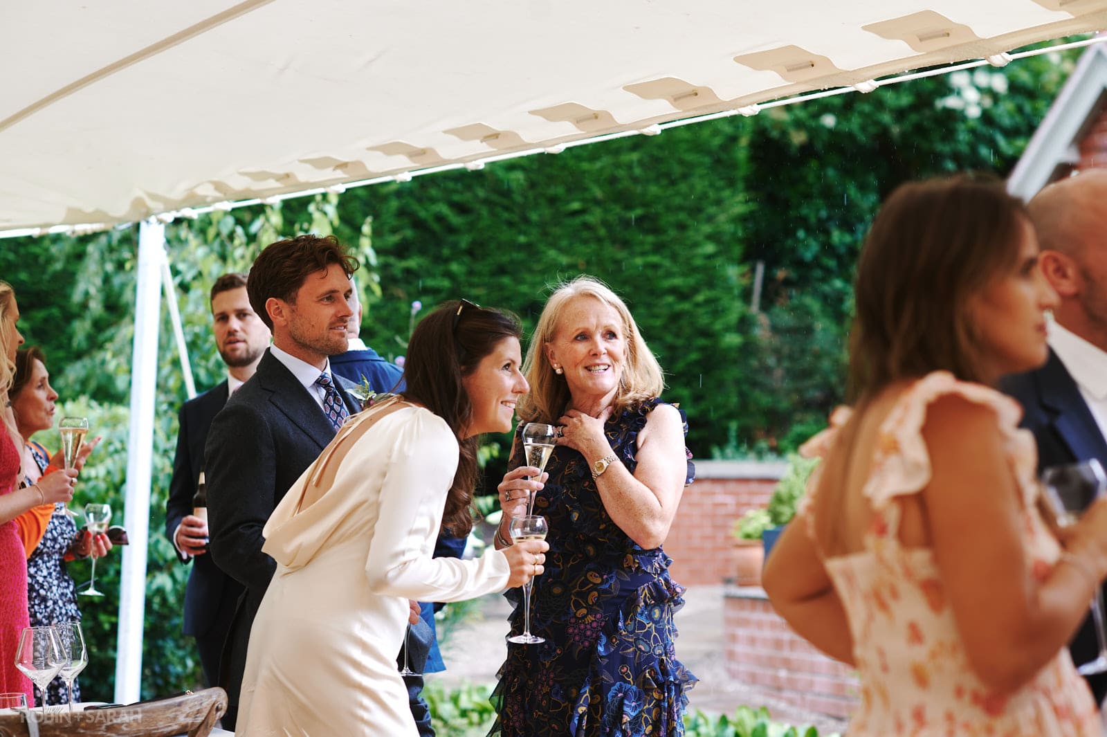 Guests relax and chat at small wedding reception
