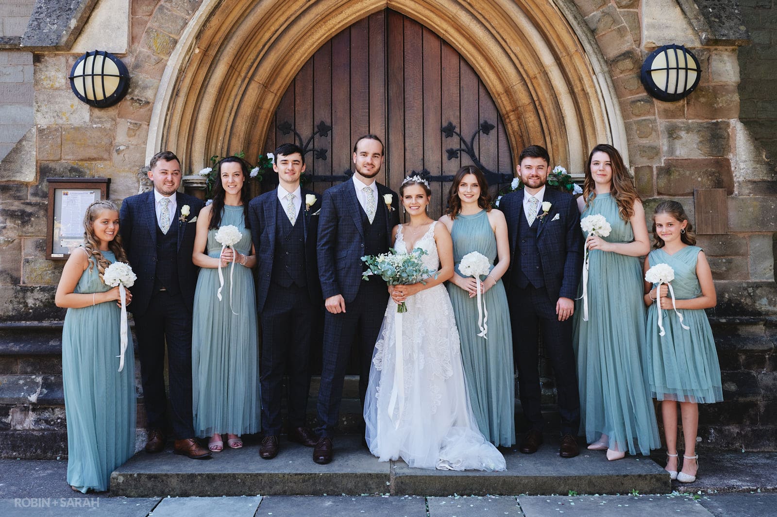 Group photo of Bride, Groom, bridesmaids and ushers at St Peter's church Bromsgrove