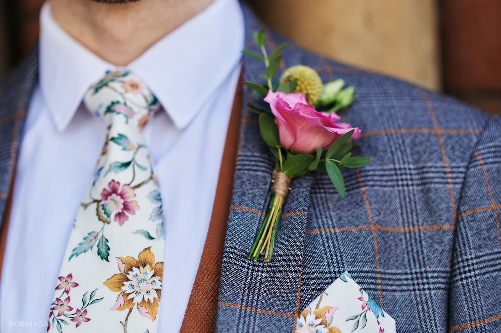 Details of groom's tie and buttonhole flower