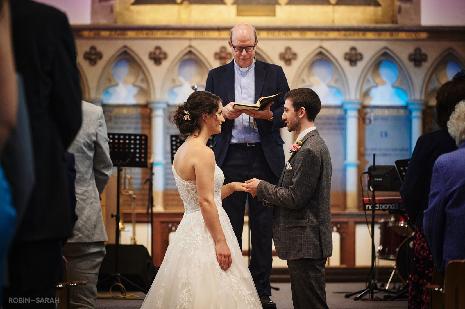Bride and groom exchange wedding rings in St Pauls church Leamington Spa