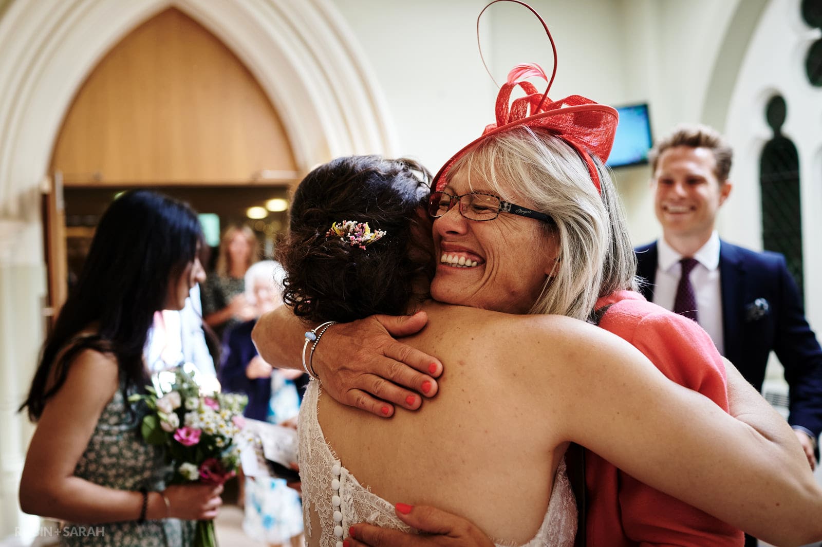 Guest hugs bride after wedding ceremony at St Pauls church in Leamington
