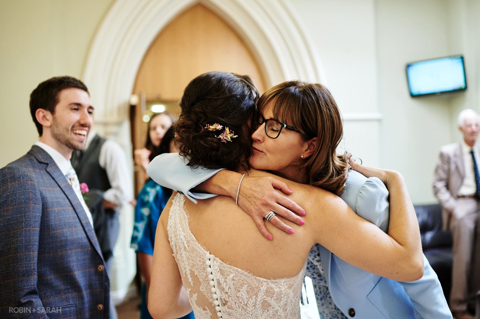 Guest hugs bride after wedding ceremony