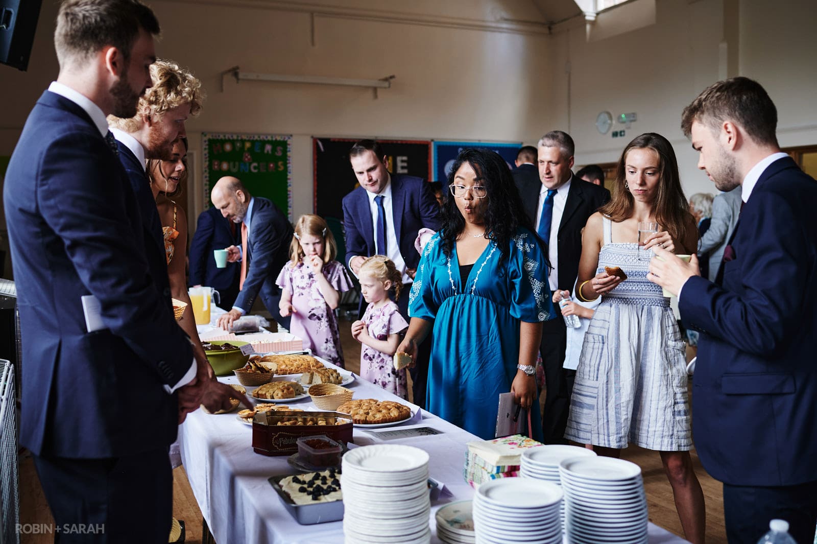 Guests choose from variety of cakes after wedding ceremony