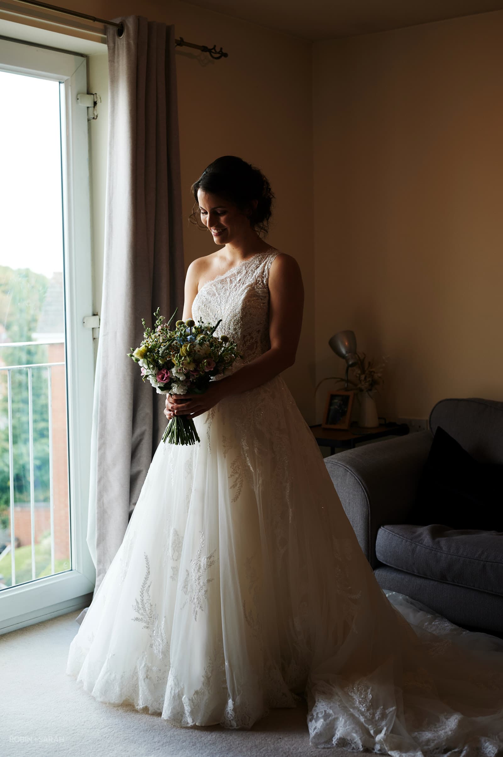Full length portrait of bride holding bouquet
