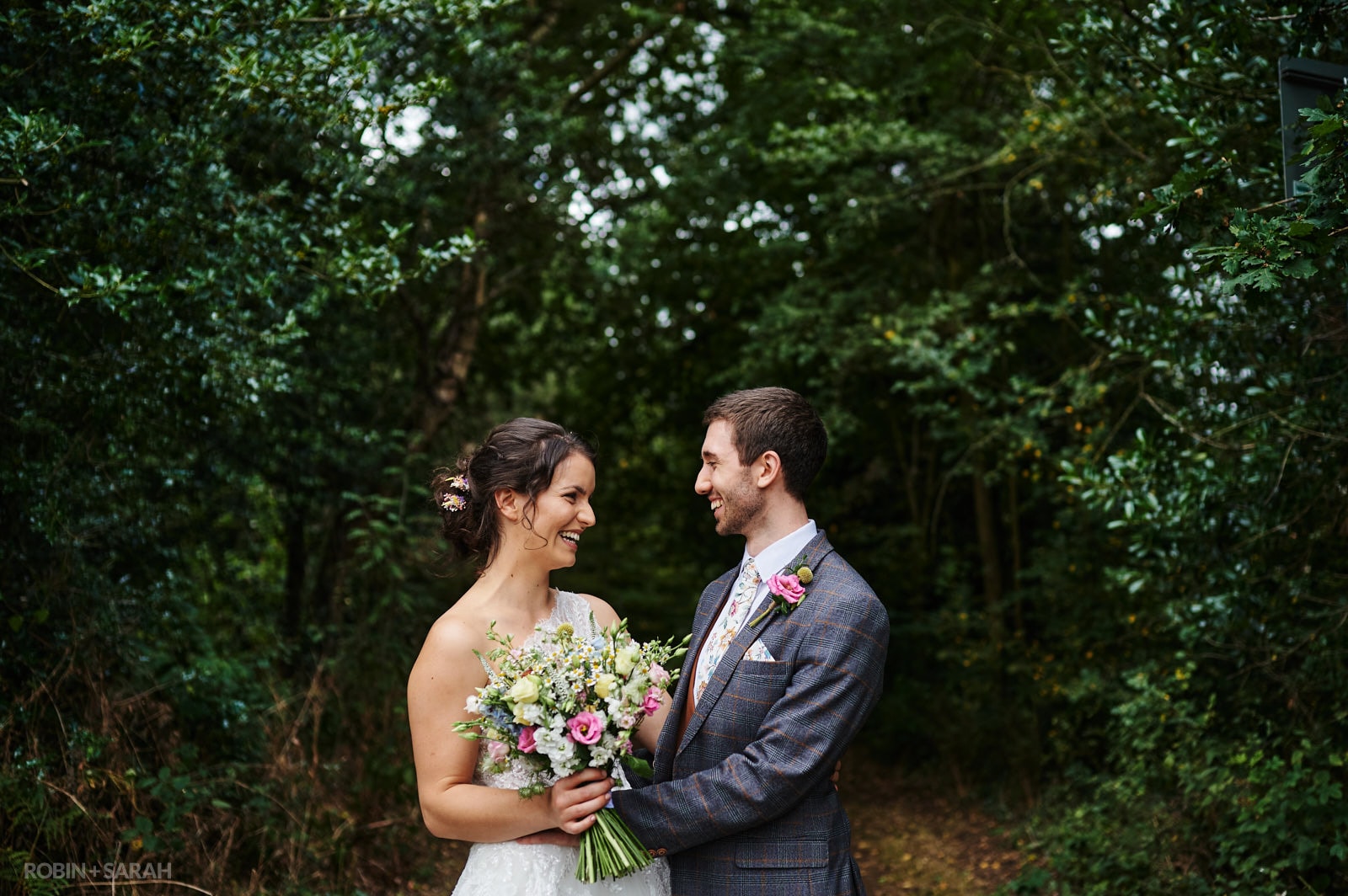 Bride and groom enjoy time together in beautiful woodland park