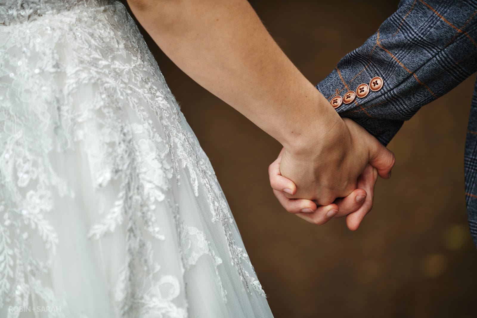 Bride holds groom's hand