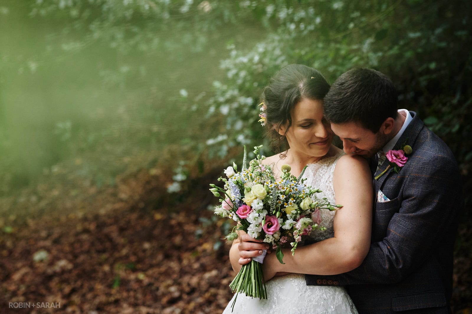 Bride and groom share a quiet moment in beautiful woodlands