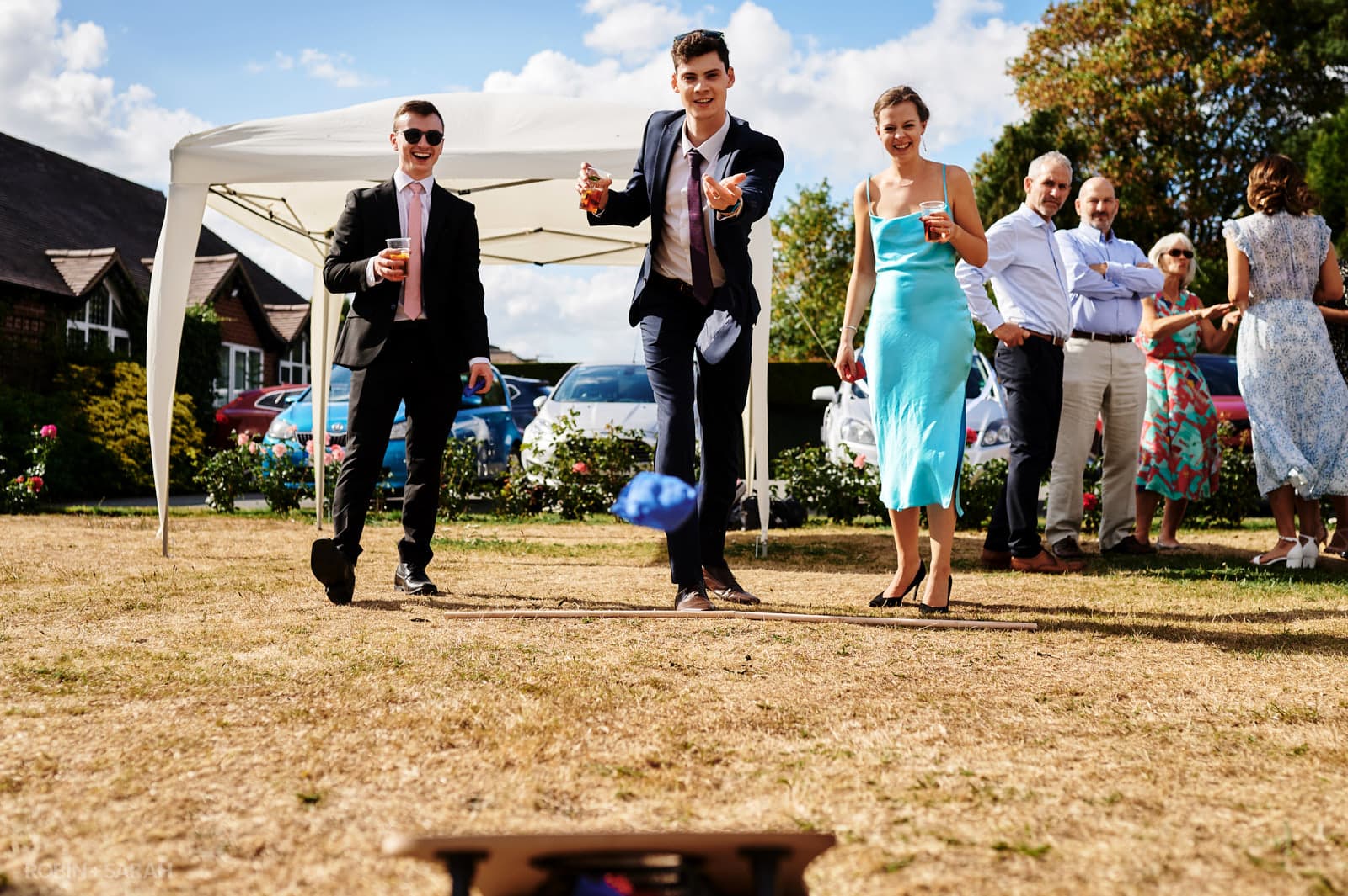 Guests play garden games at village hall wedding in Warwickshire