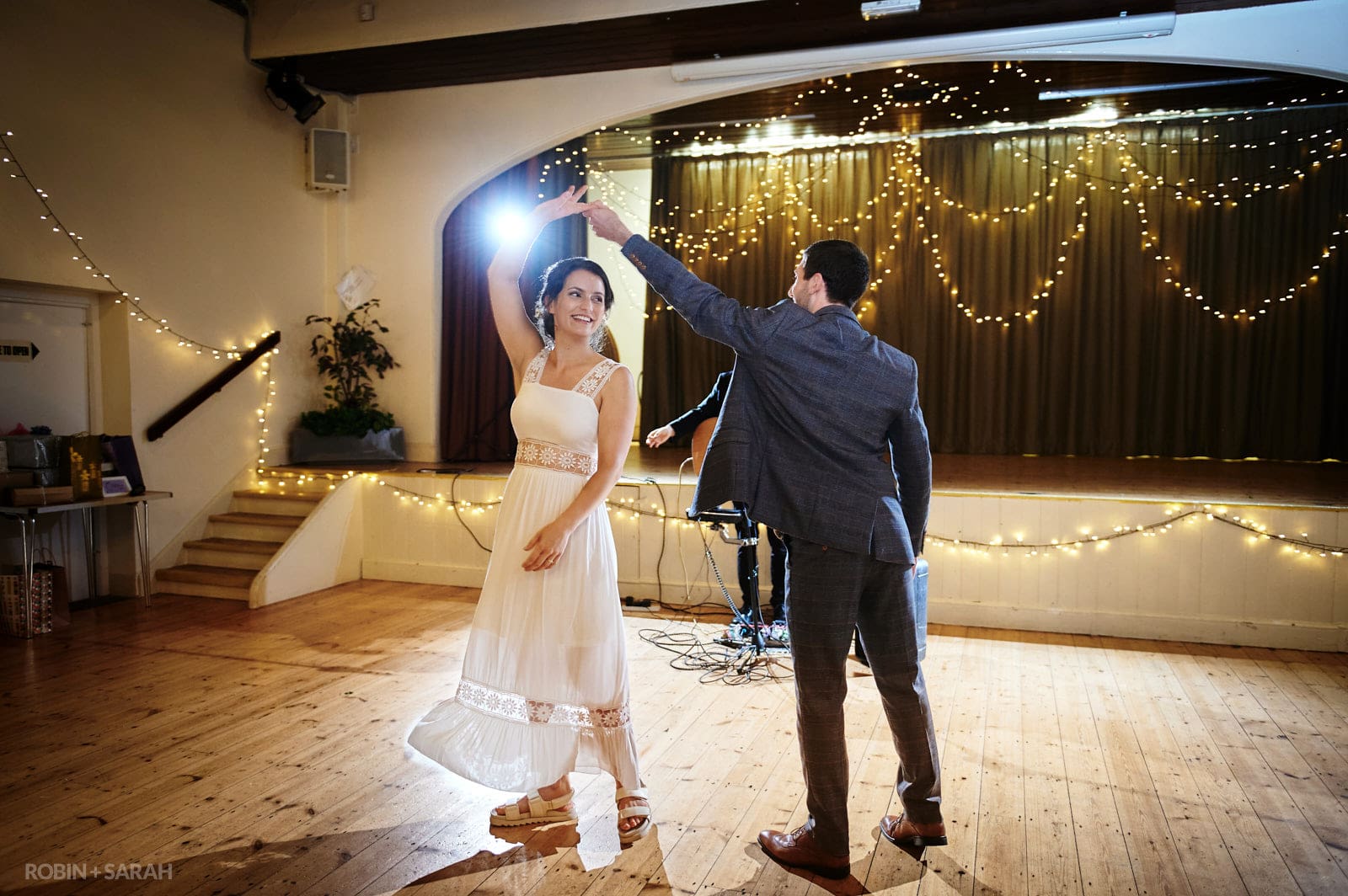 Bride and groom first dance in village hall