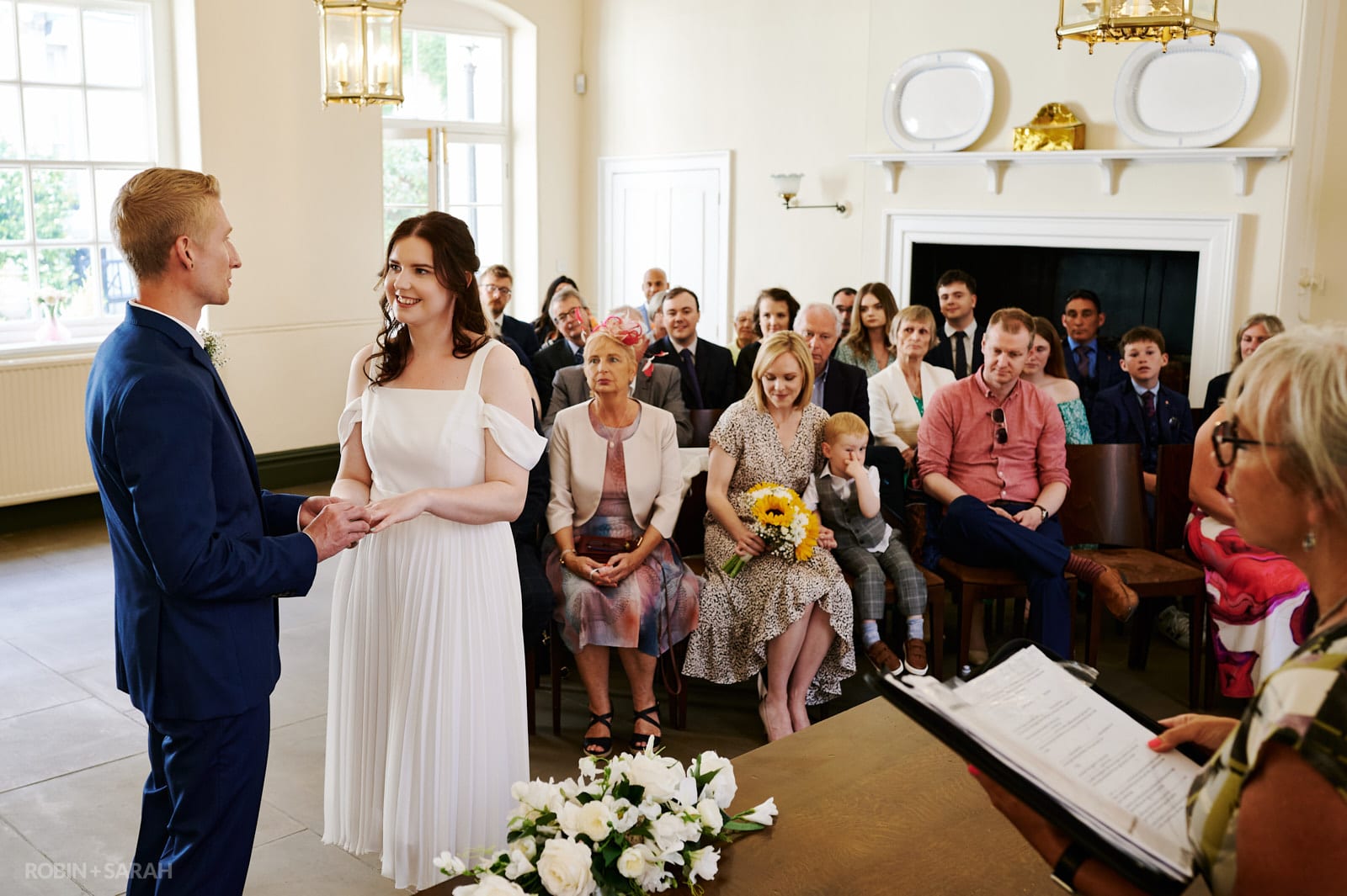 Bride and groom exchange wedding rings during wedding ceremony at Priory Place Registration Office in Doncaster
