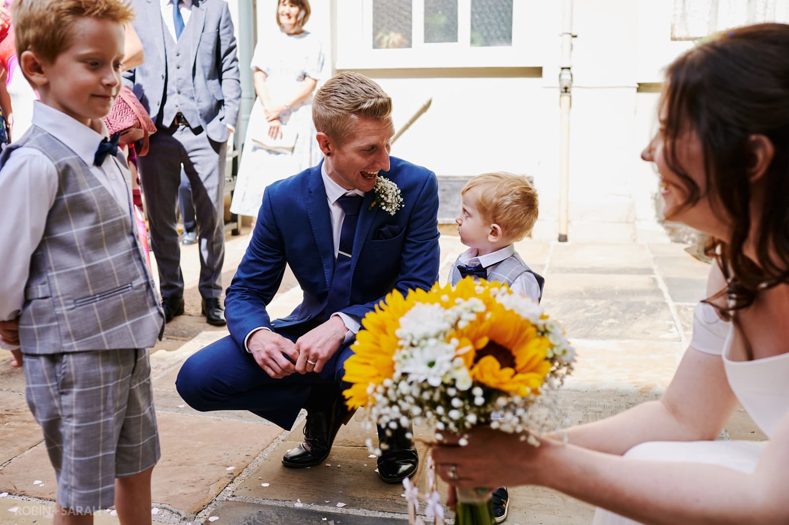 Bride and groom chat to kids after wedding ceremony