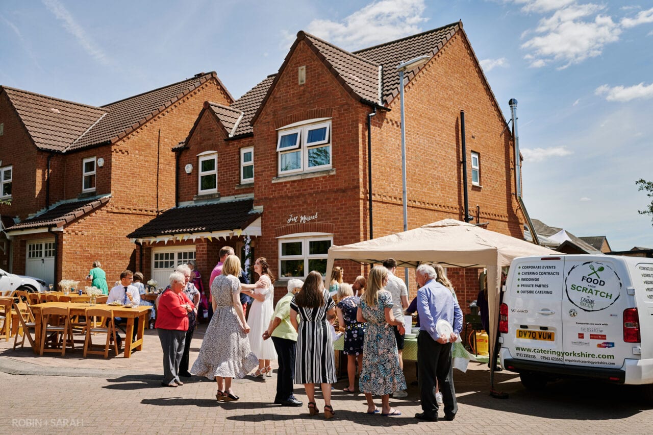 Guests queue up for food at DIY wedding held at home