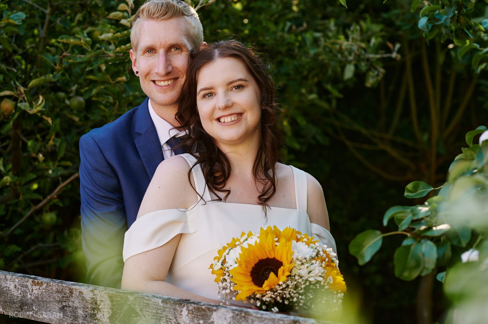 Bride and groom together in gardens at DIY wedding held at their home
