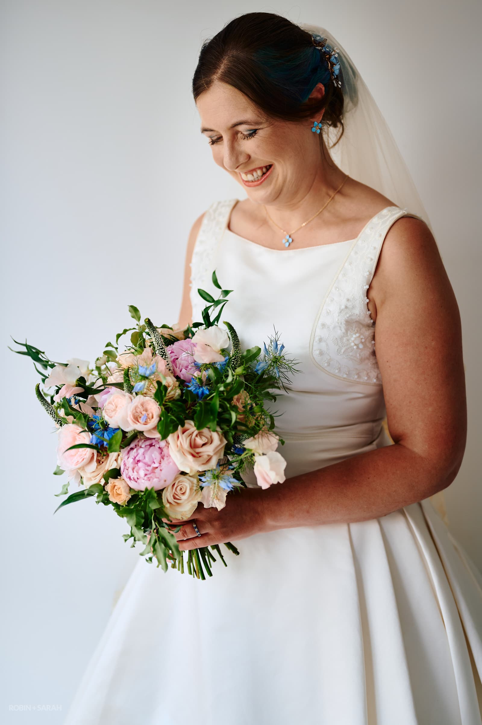 Portrait of bride holding a beautiful bouquet of flowers.
