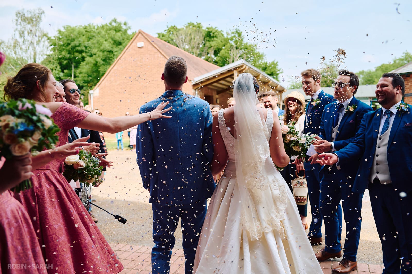 Bride and groom have confetti thrown over them at Avoncroft Museum wedding