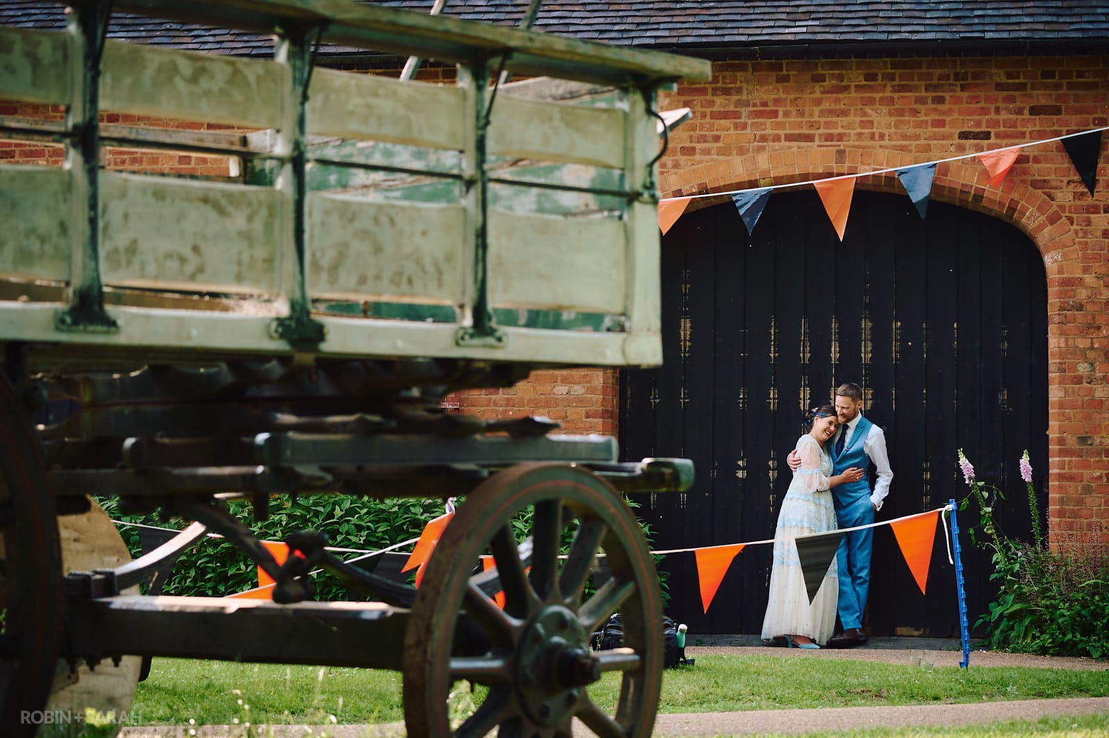 Bride and groom share a quite moment together amongst the old buildings at Avoncroft Museum.