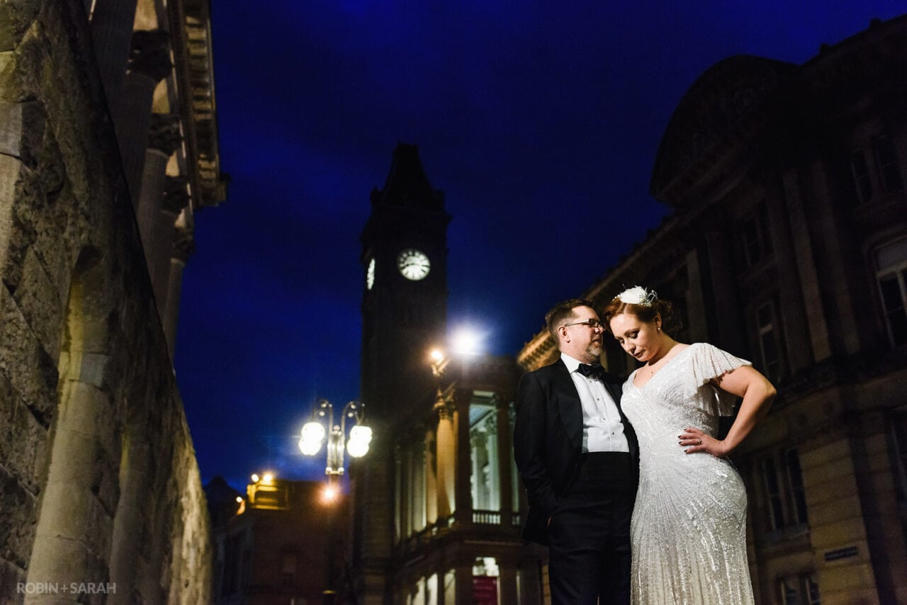 Bride and Groom outside Birmingham Town Hall at night with Birmingham Museum & Art Gallery in background