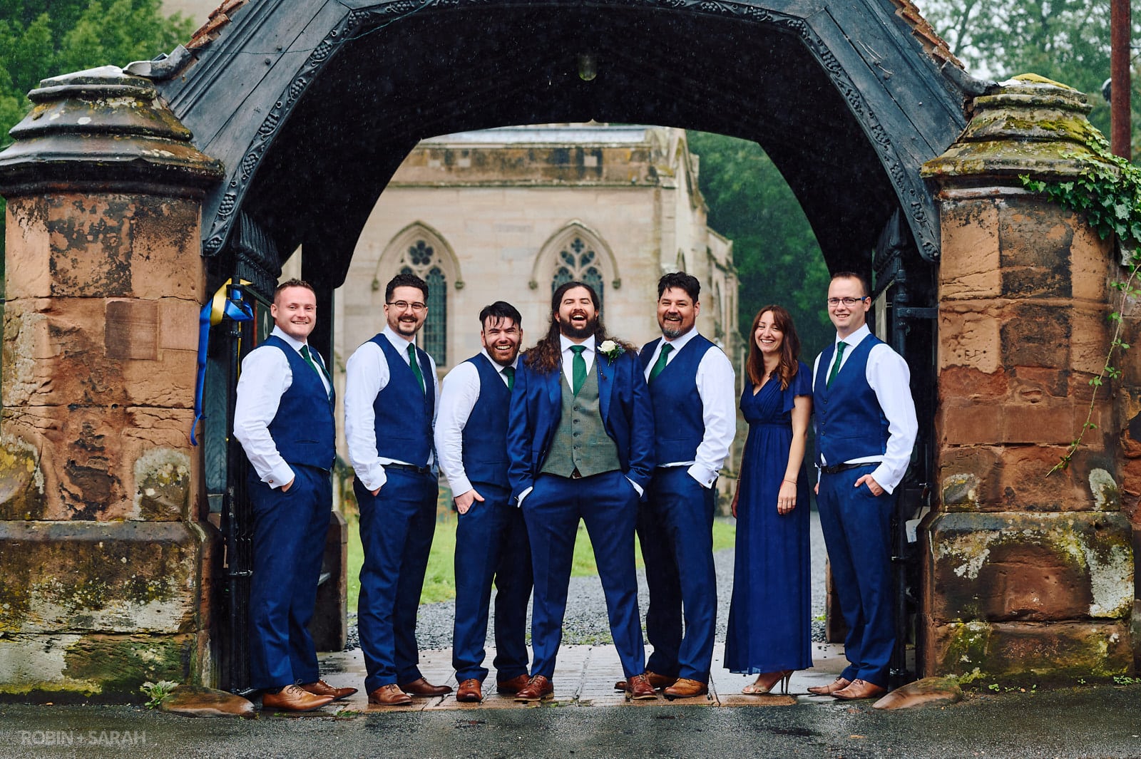 Groom and friends under lychgate at St Andrews church Ombersley
