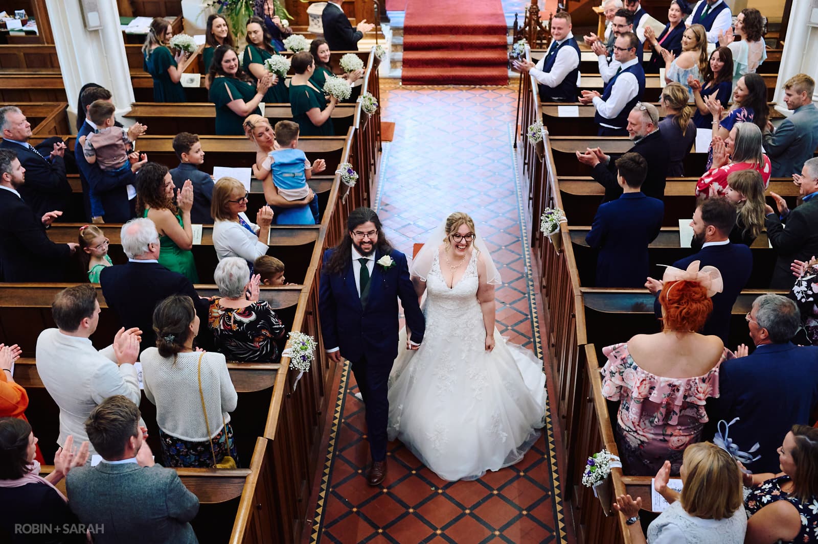 Bride and groom walk up aisle at St Andrews church