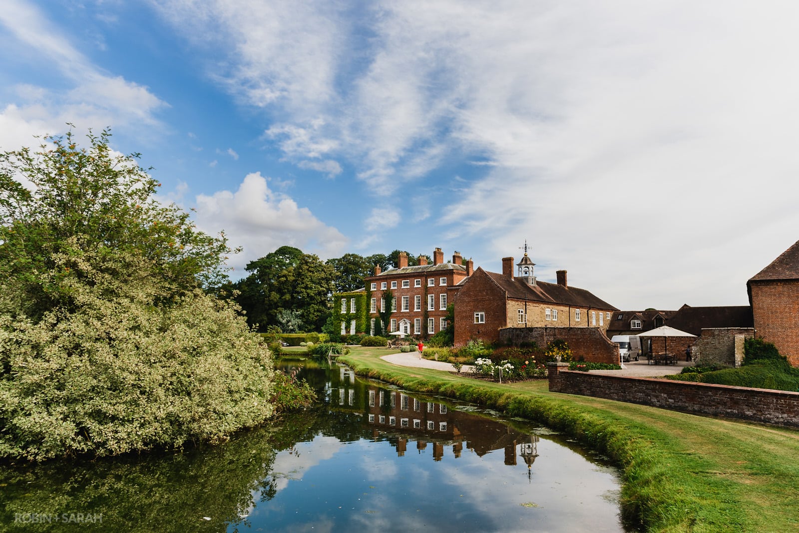 View of Delbury Hall wedding venue with beautiful pond and gardens
