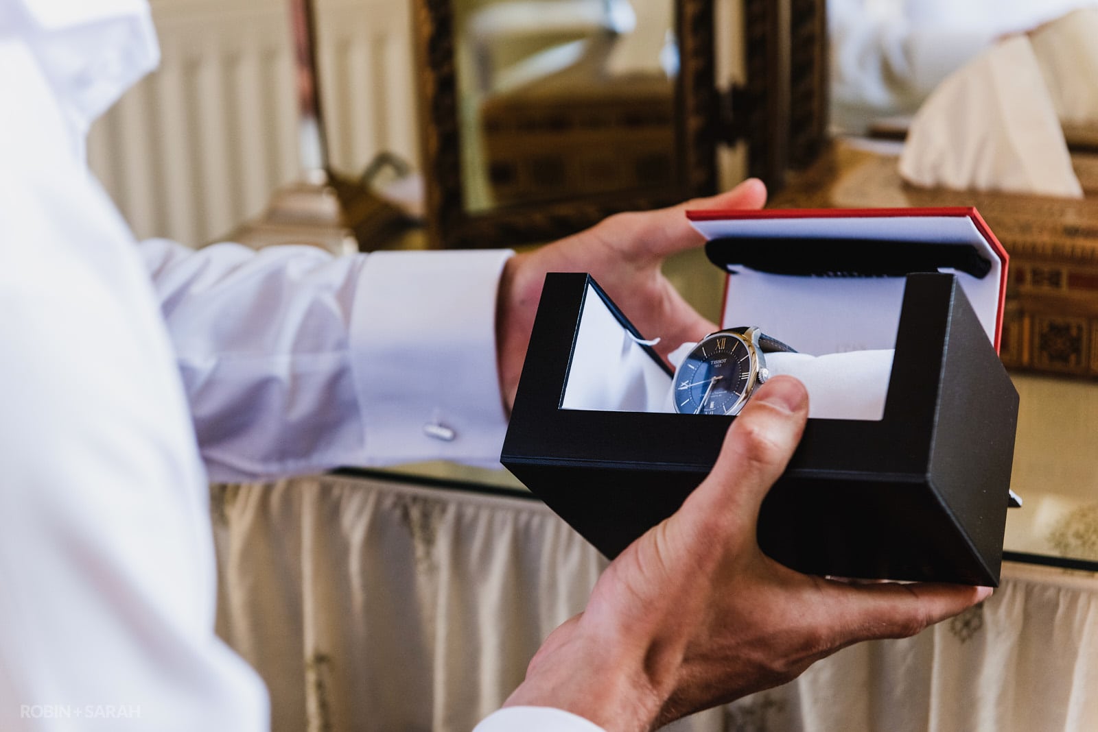 Groom opens gift of an expensive watch