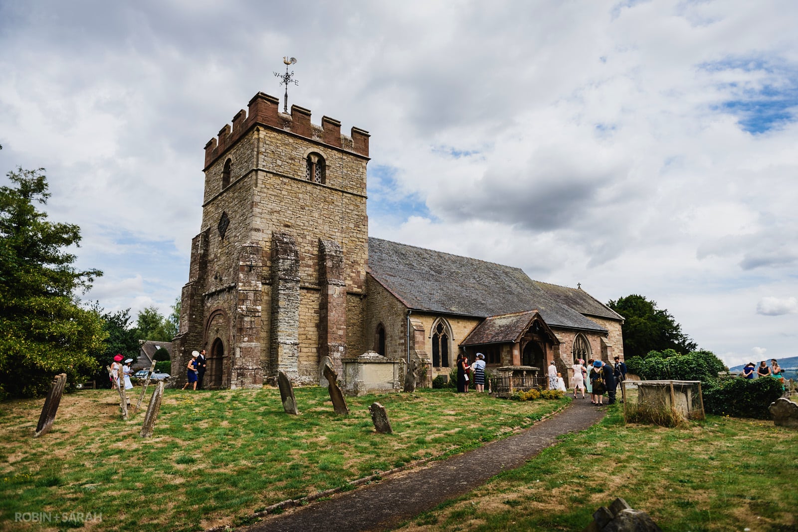 St Peter's Church in Diddlebury with wedding guests arriving