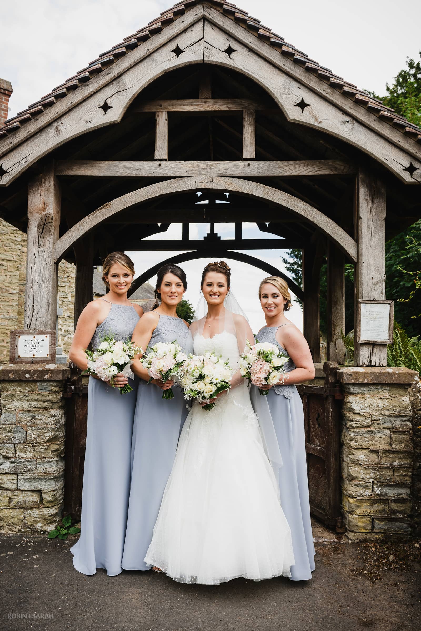 Group photo of bride and bridesmaids at St Peter's Church Diddlebury