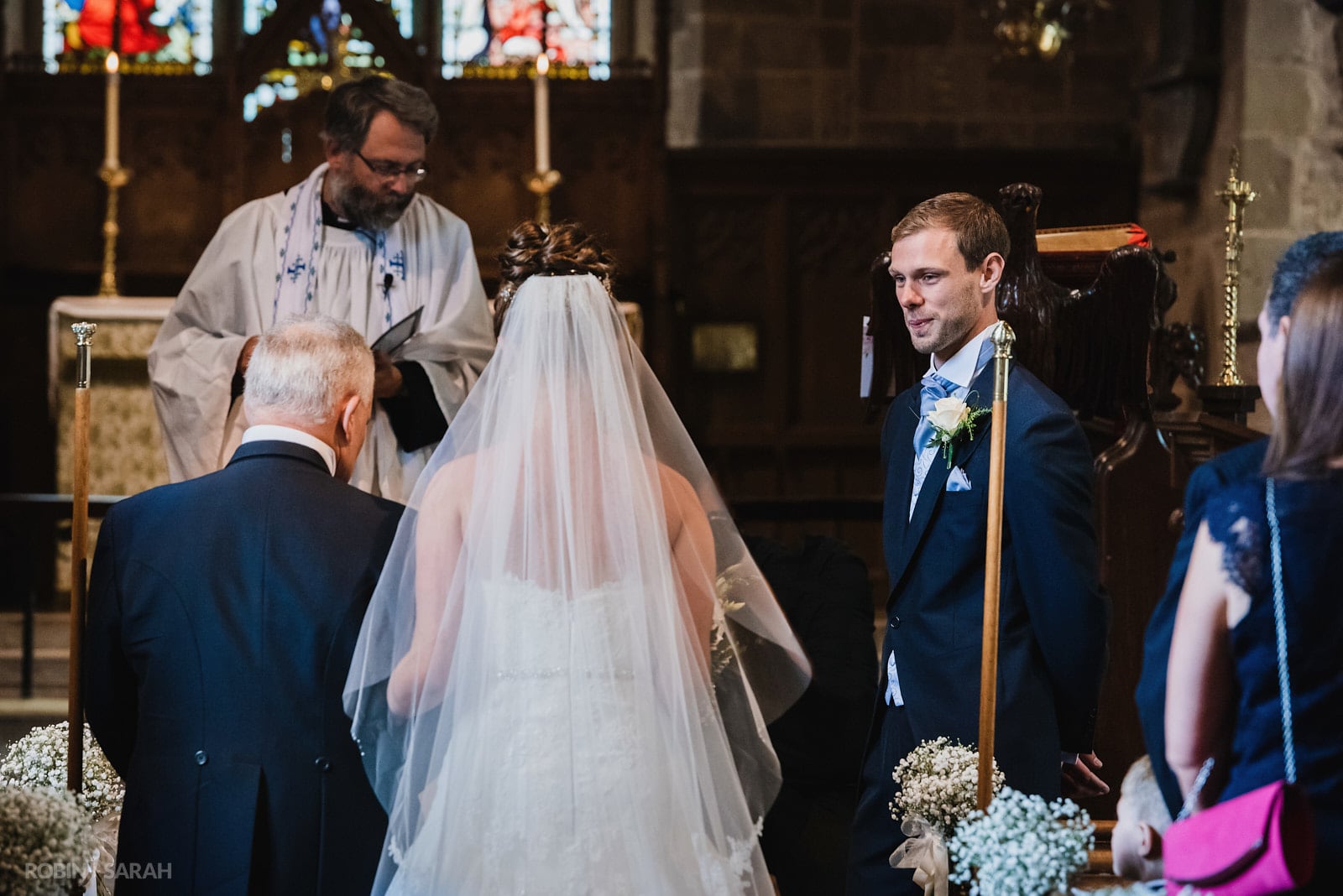 Groom sees bride in her wedding dress as she arrives in church