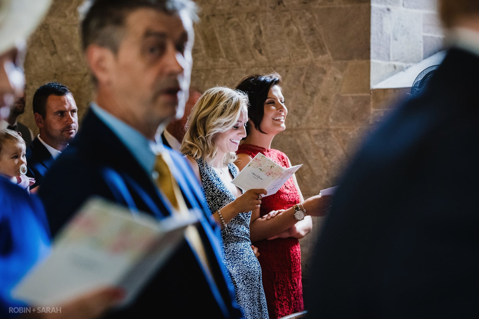 Guests singing at church wedding ceremony