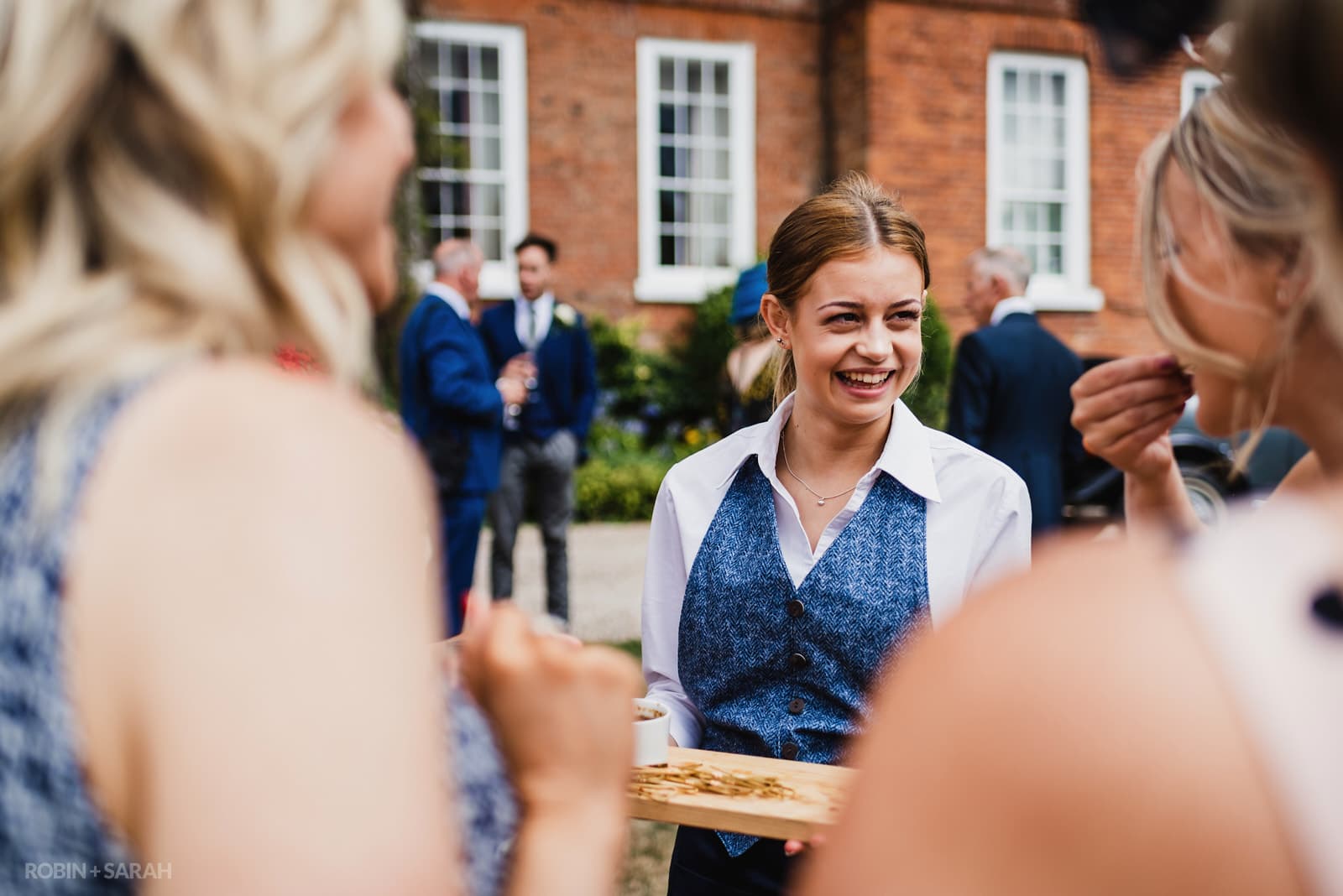 Guests drink and chat during wedding reception