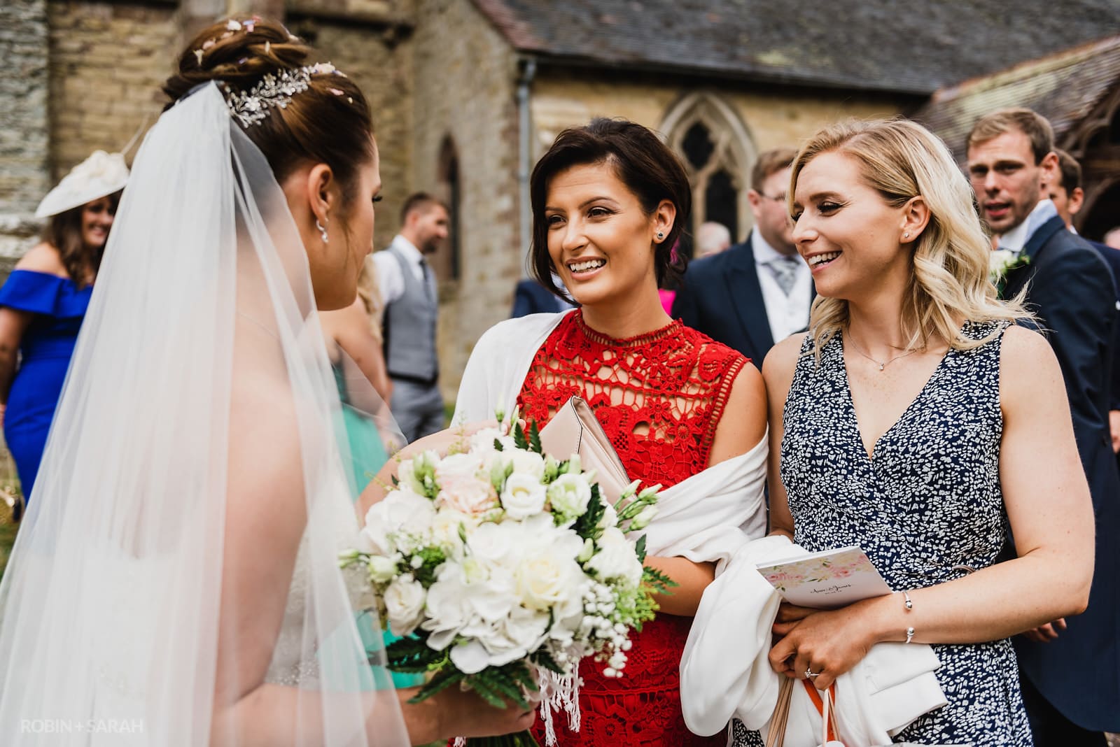 Bride chats to wedding guests after wedding ceremony