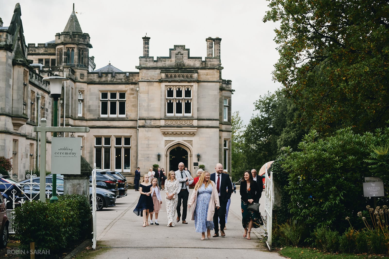 Wedding guests walk from Hampton Manor main house to The Birches for ceremony