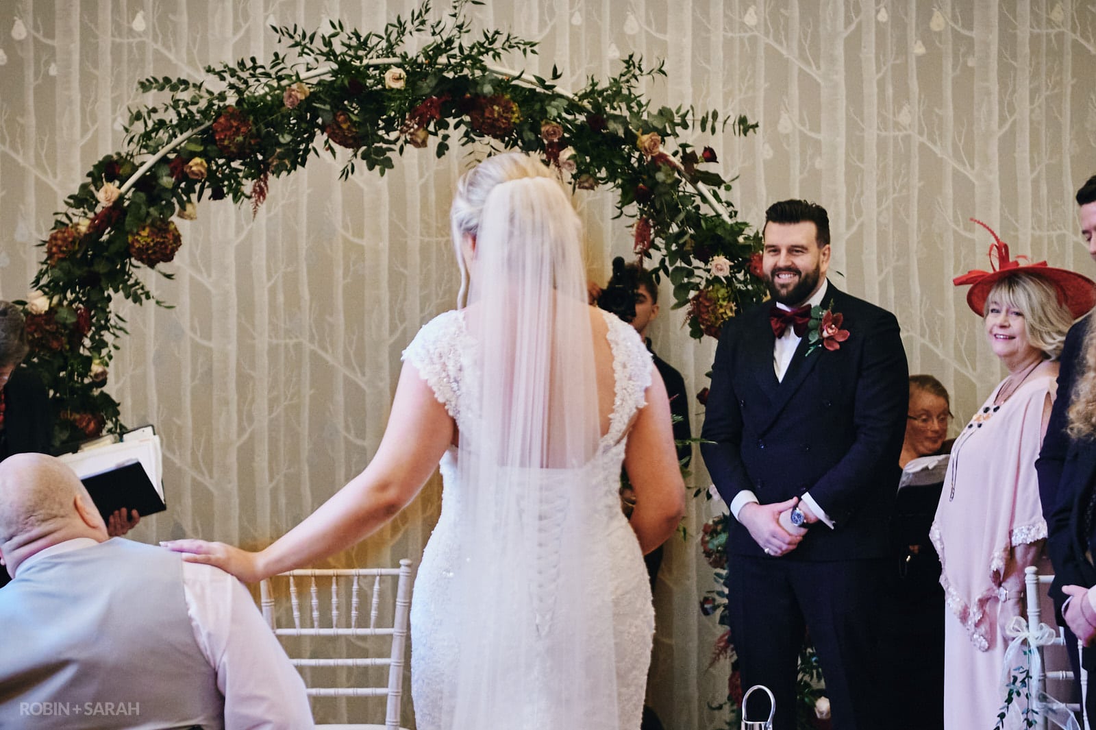 Bride and dad walk up aisle as groom and guests watch