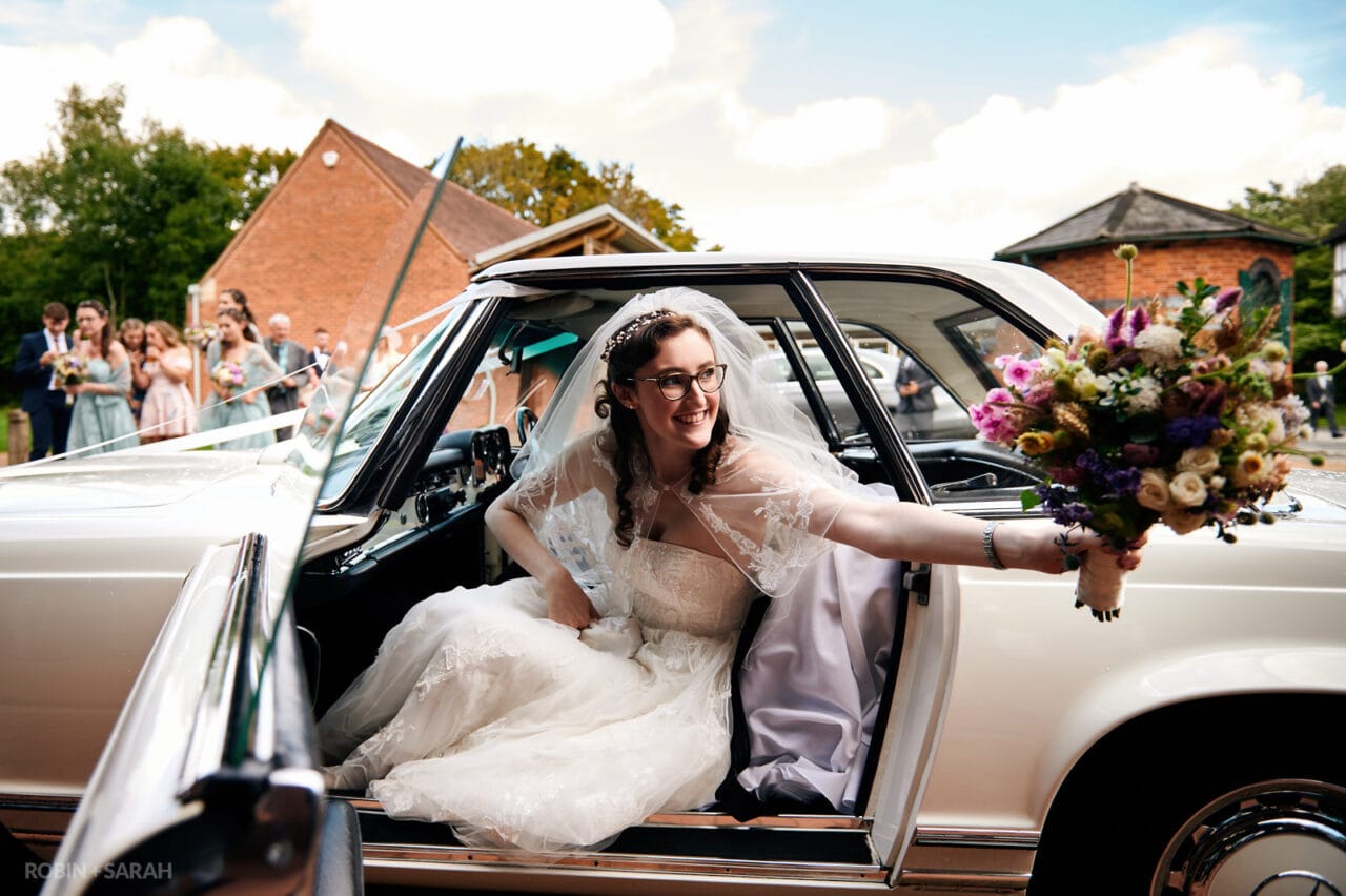 Bride arrives at Avoncroft Museum wedding reception in old Mercedes car
