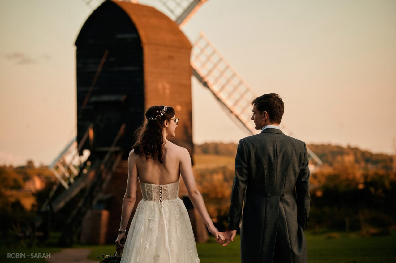 Bride and groom at Avoncroft Museum with windmill in the background