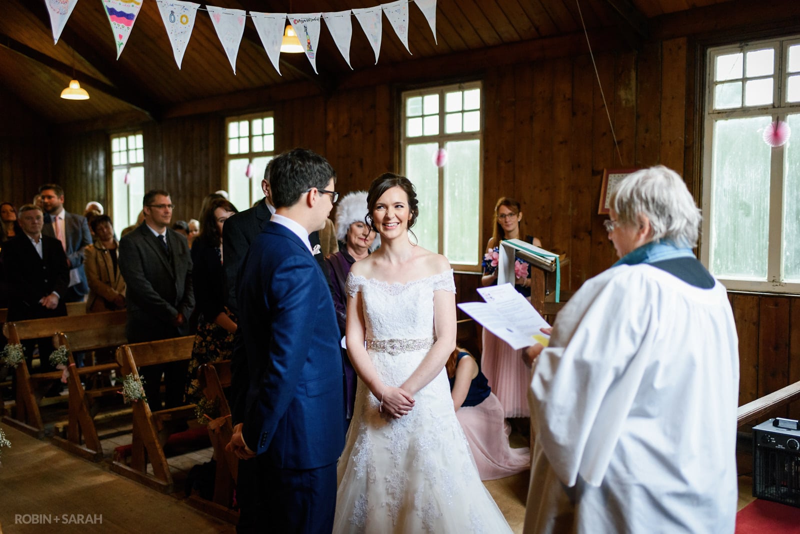 Bride and groom exchange vows during wedding blessing at Avoncroft Museum
