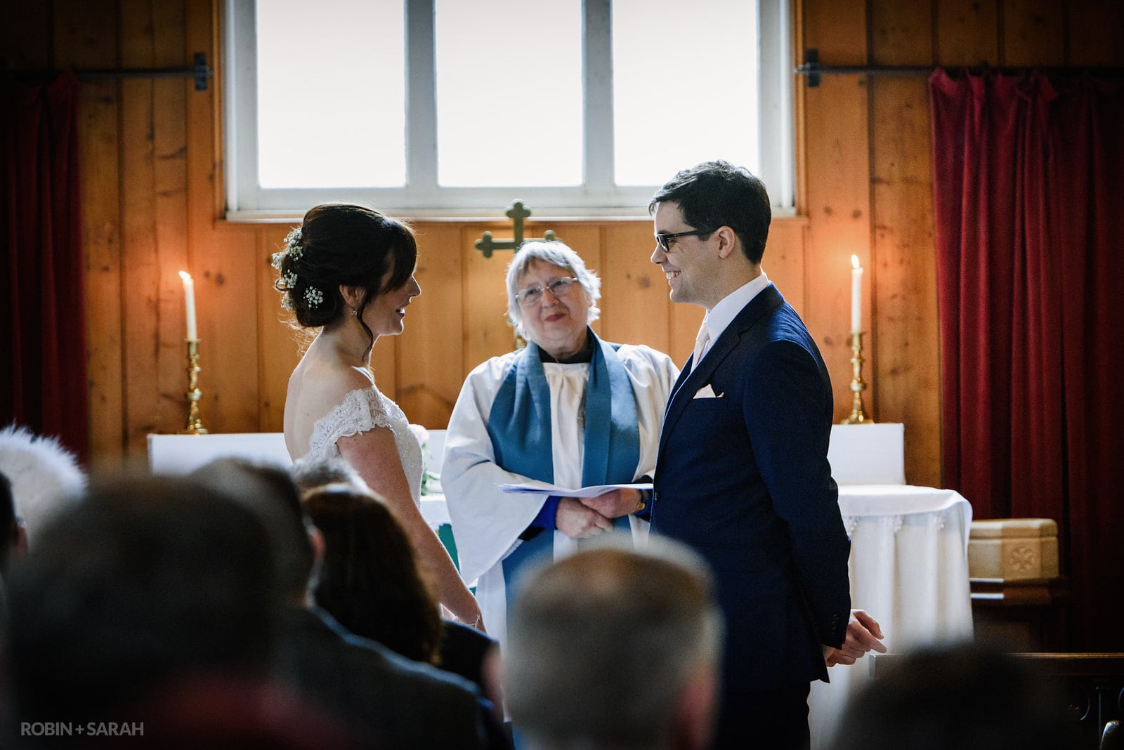 Bride and groom exchange wedding vows in Mission Church at Avoncroft Museum