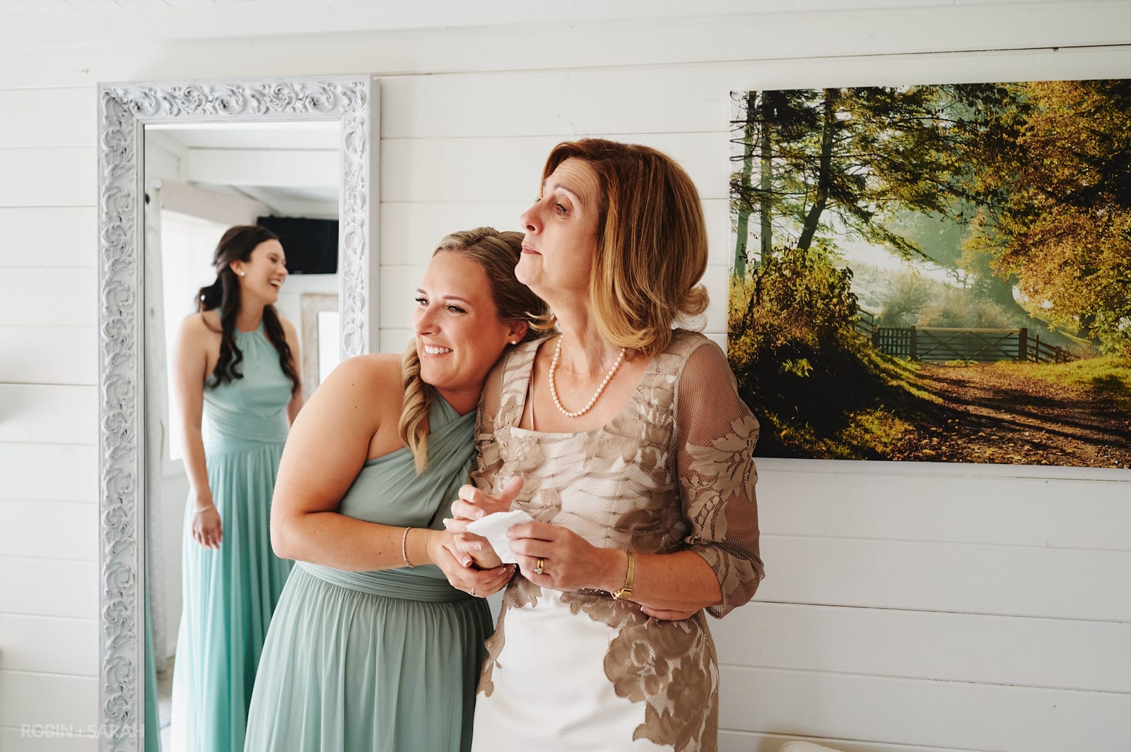 Bridesmaids and mum react to seeing bride in her wedding dress