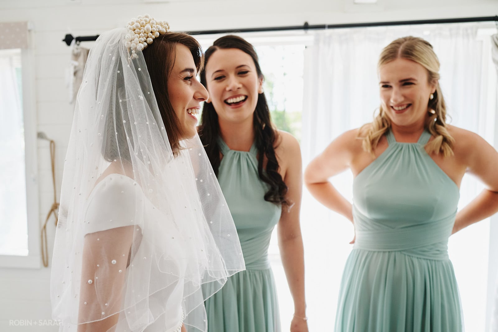 Bridesmaids react to seeing bride in her wedding dress