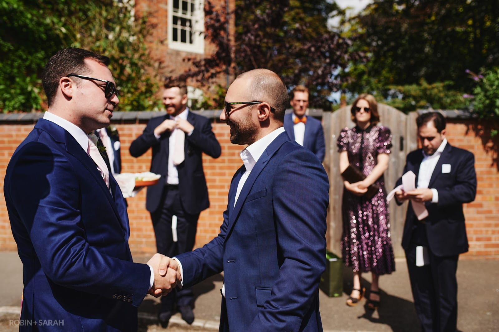 Groom greets wedding guests at Peter's church Dunchurch