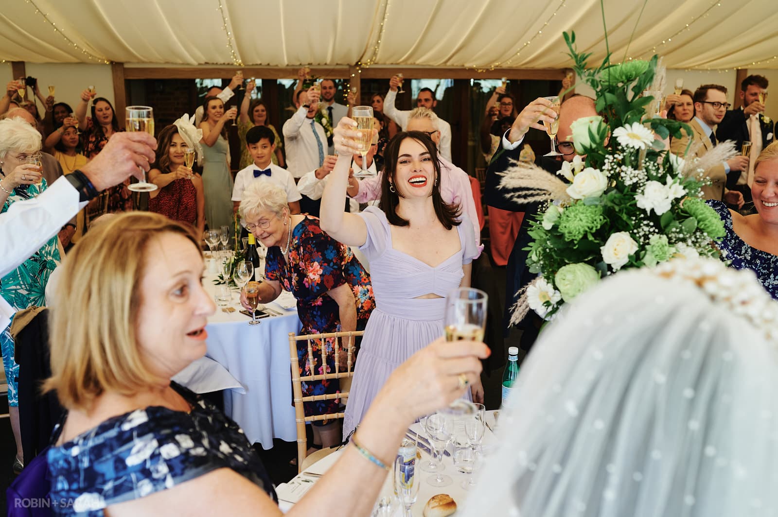 Wedding guests raise a toast during speeches